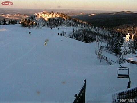 &quot;First Tracks&quot; Skies and Boarders take advantage of beautiful early morning conditions as the sun rises over Tremblant.